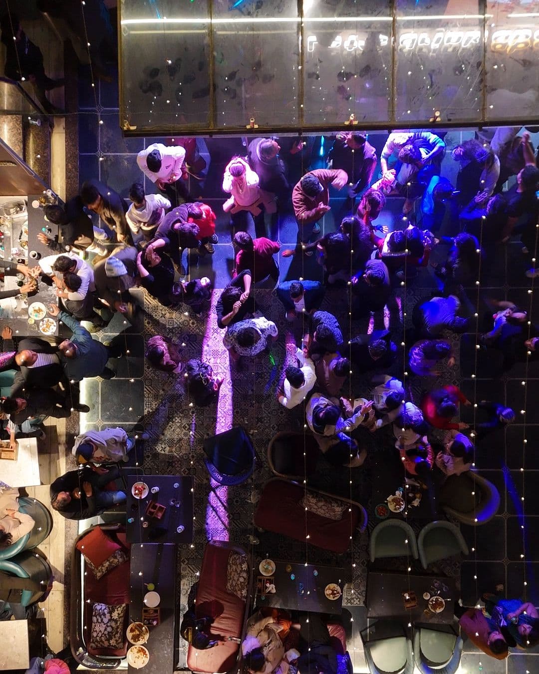 The New Year’s Eve 2025 crowd at Altitude seen from straight above, dancing between the tables